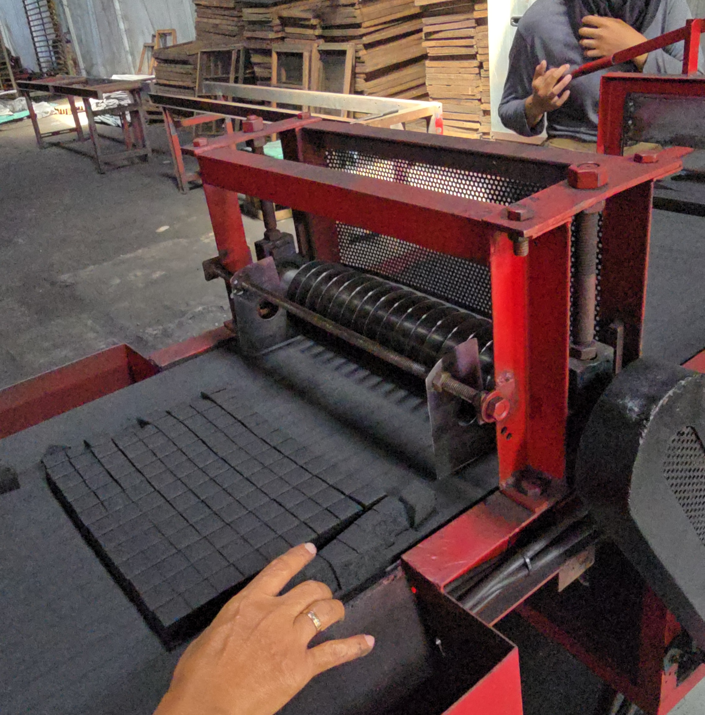Cutting coconut charcoal briquettes to the agreed dimensions