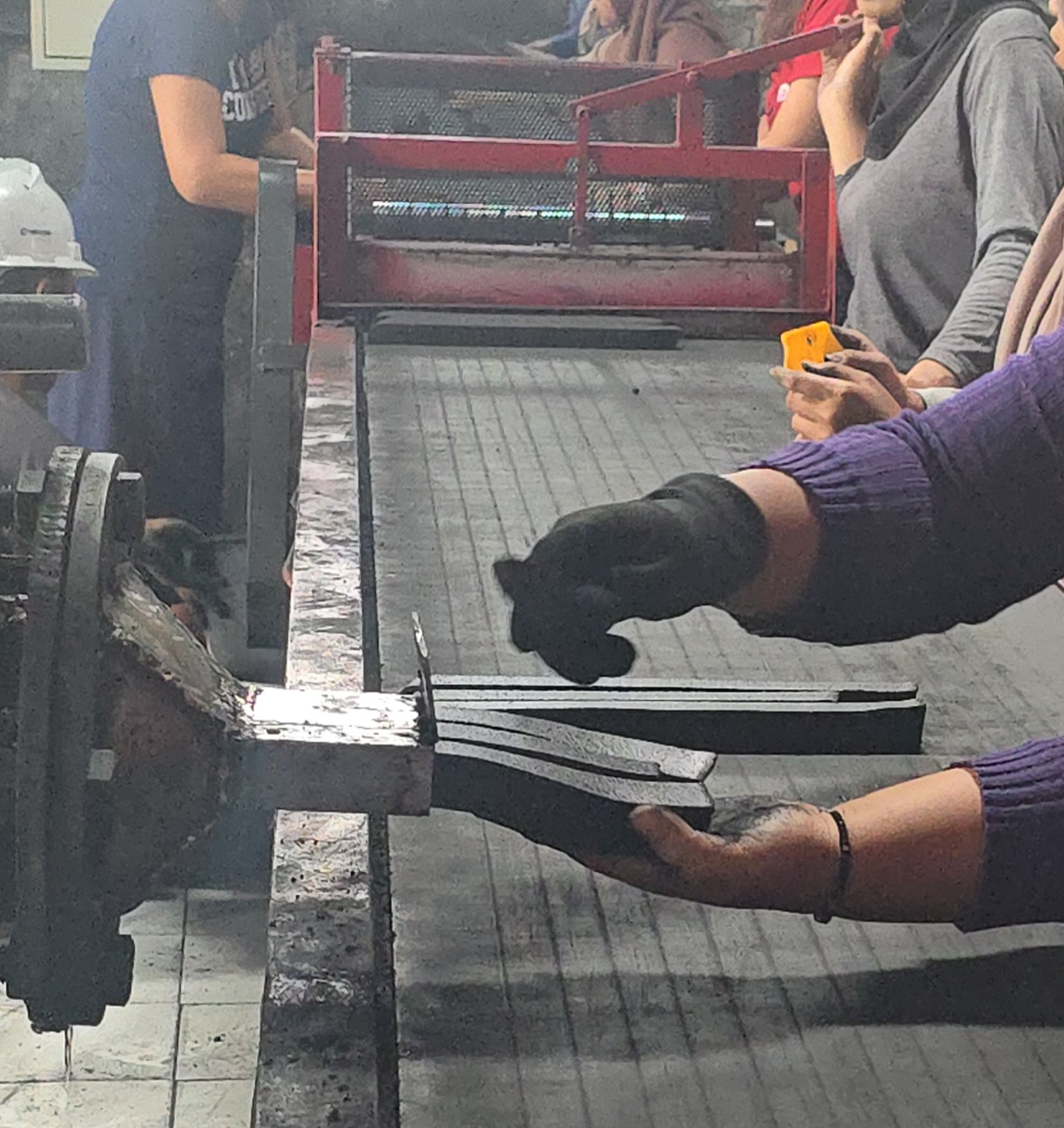Forming coconut charcoal briquettes at a production partner