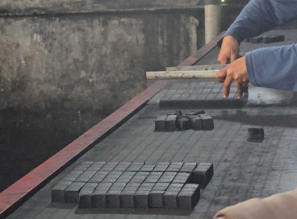 Manual quality inspection of coconut charcoal briquettes