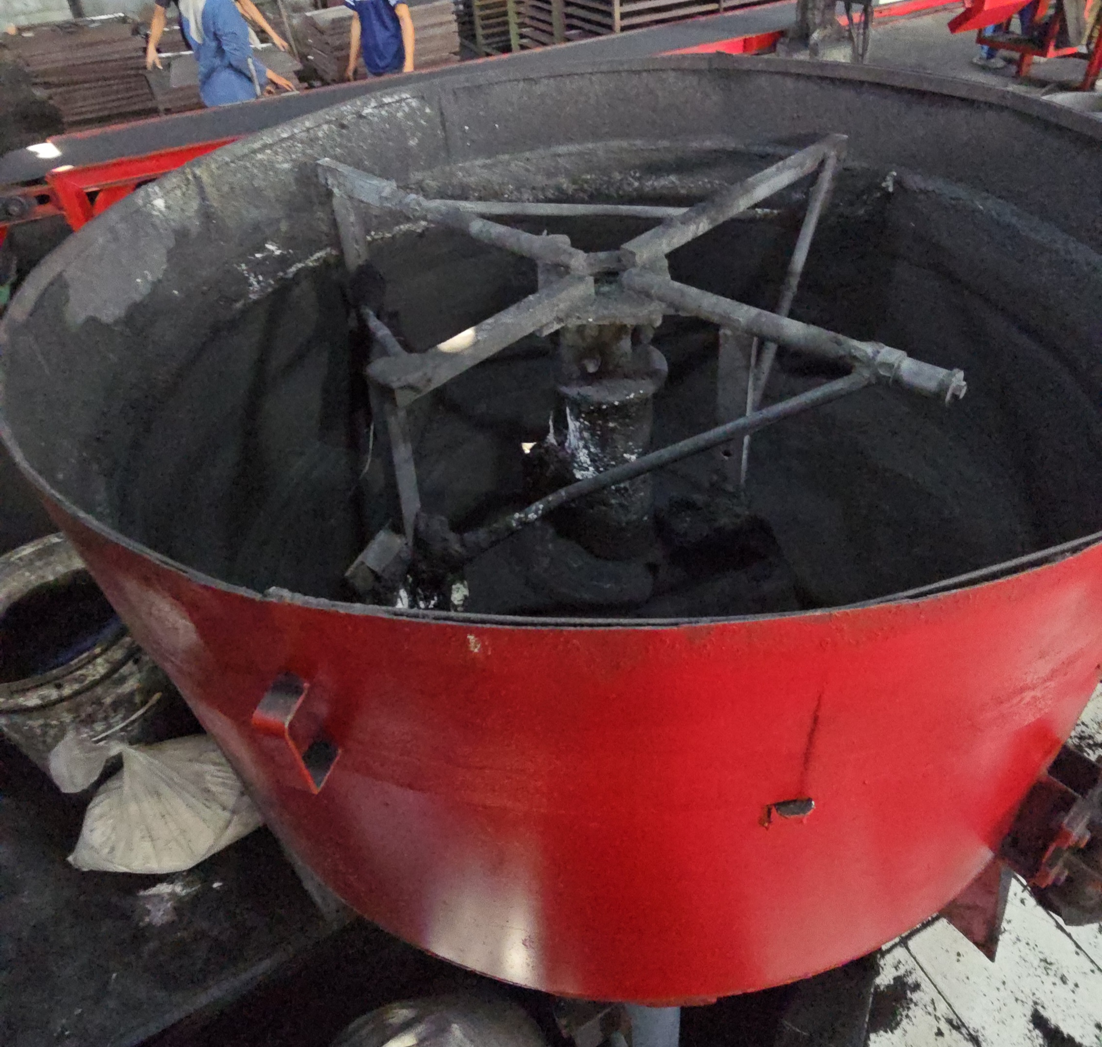 Mixing charcoal briquette materials at a production partner