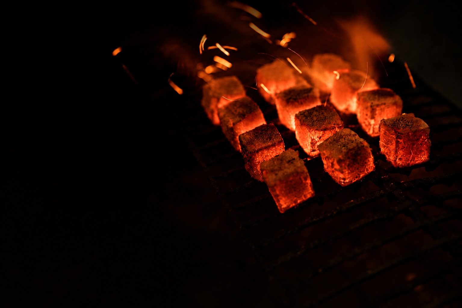 Indonesian coconut charcoal briquettes glowing during a burning evaluation