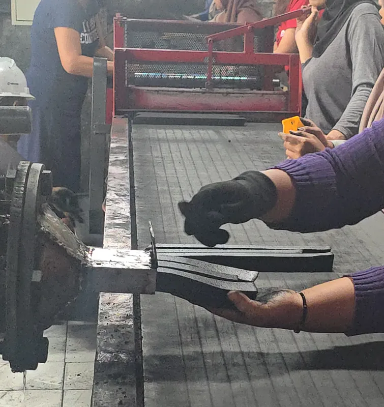 Forming coconut charcoal briquettes at a production partner